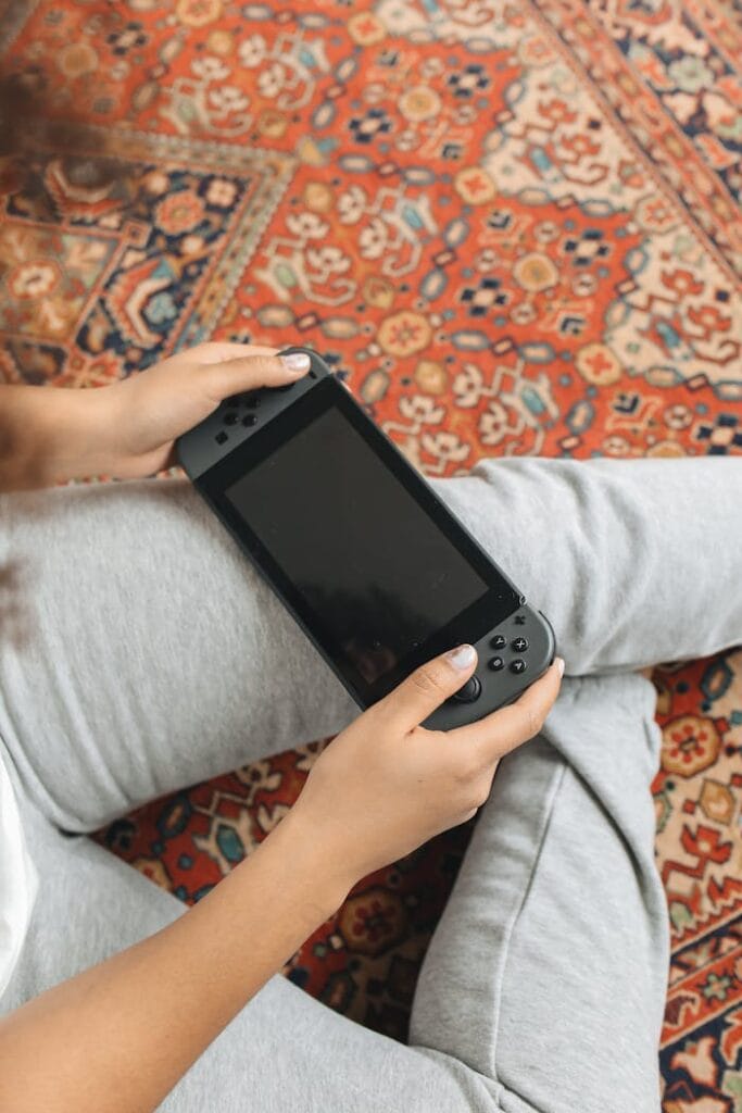 Person Holding a Video Game Console